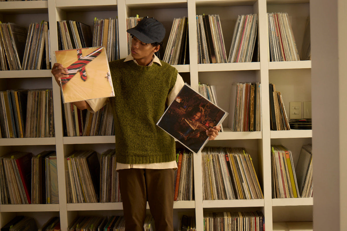 Person browsing a vinyl record collection as interest in vinyl records rises